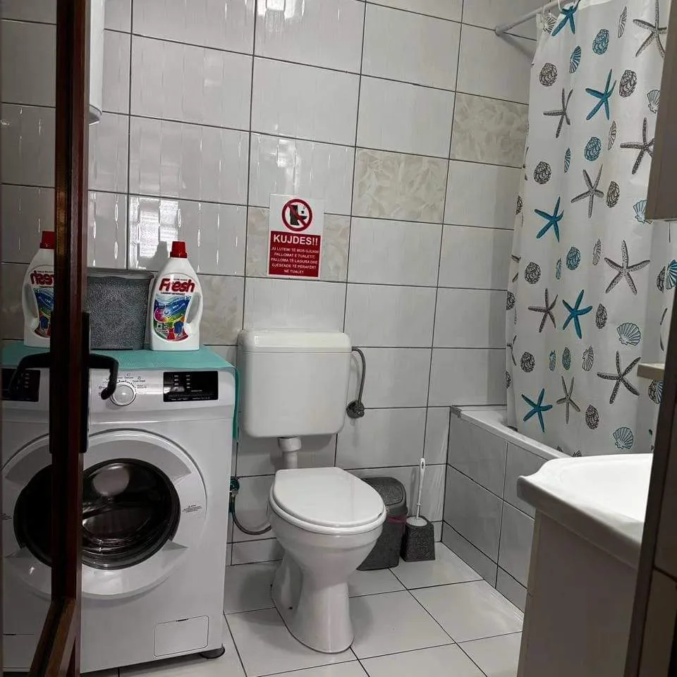 Bathroom with washing machine in Apartment 1
