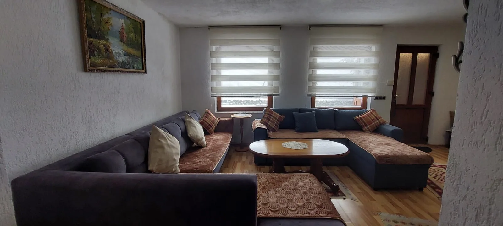 Seating area with large windows in Apartment 1