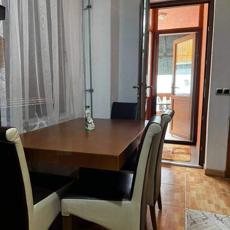 Dining table by the balcony door in Apartment 2
