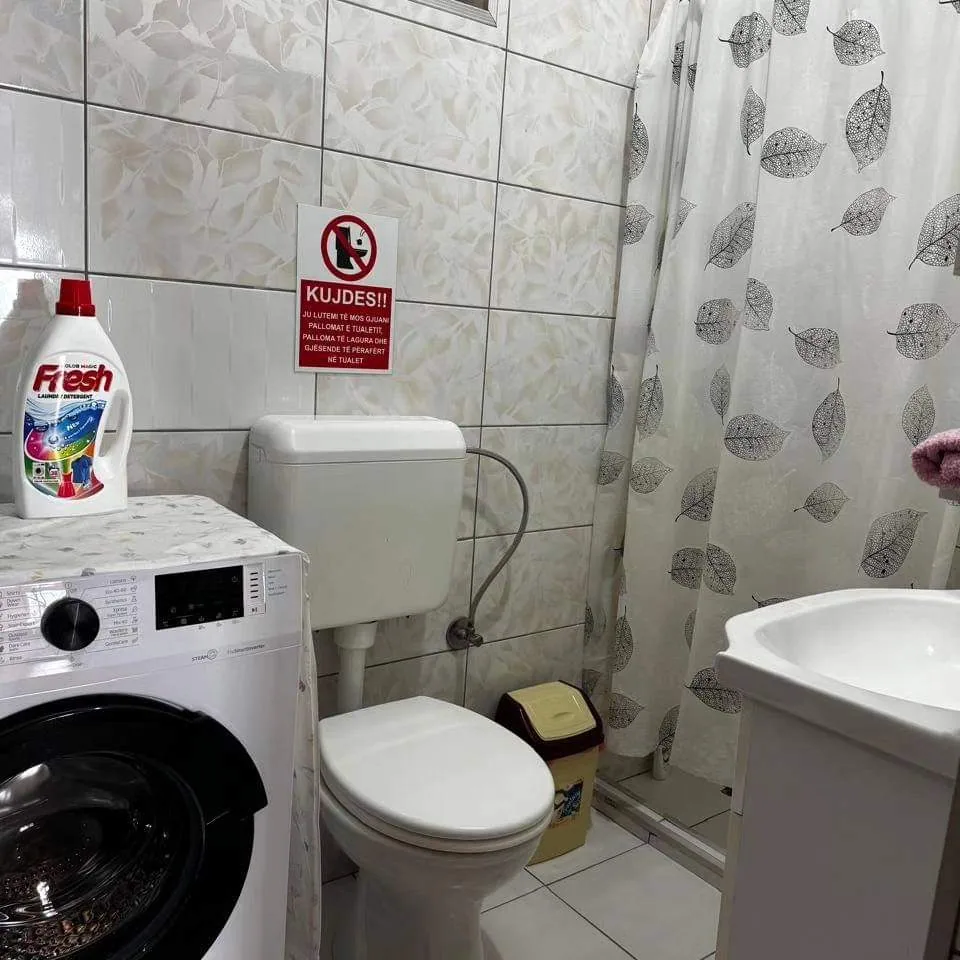 Bathroom with washing machine in Apartment 2
