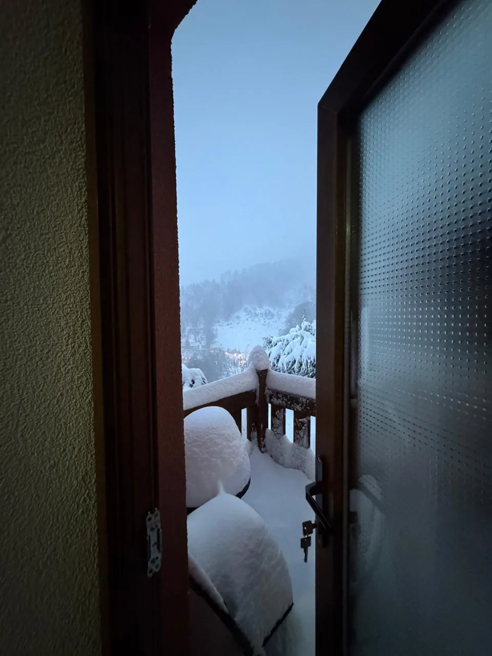 Snow-covered balcony of Apartment 2 in winter