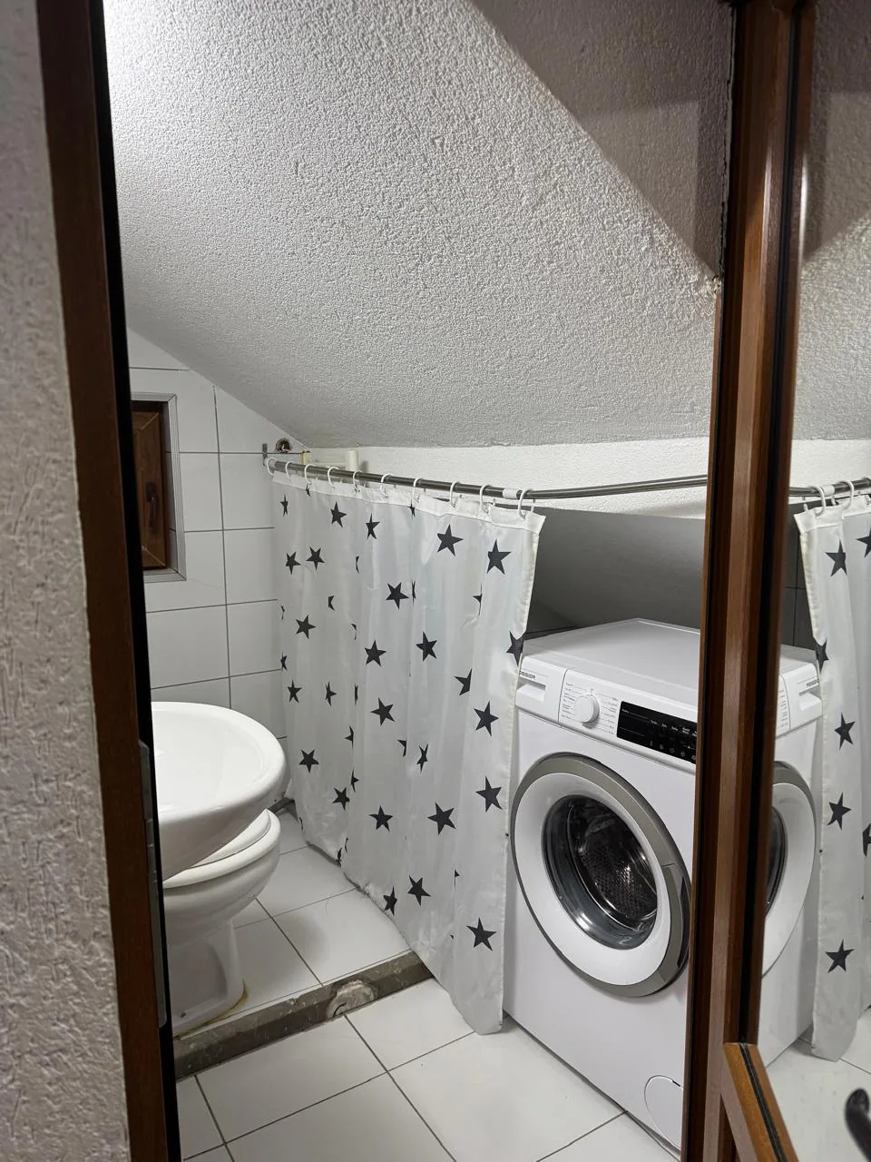 Bathroom with washing machine in Apartment 3