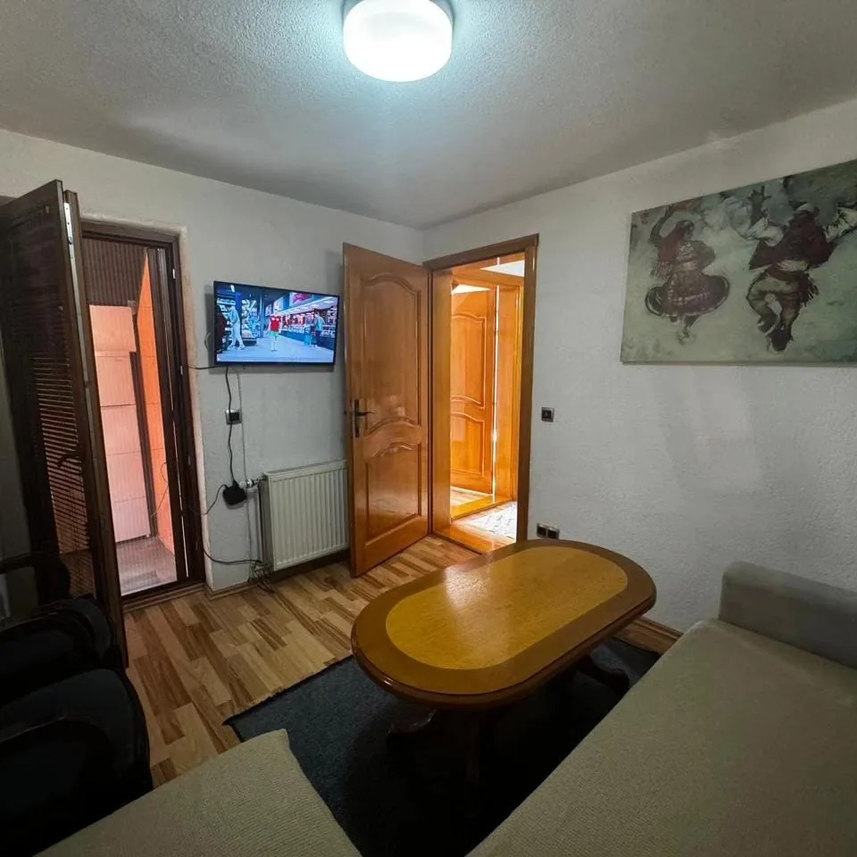 Living area with television in Apartment 3